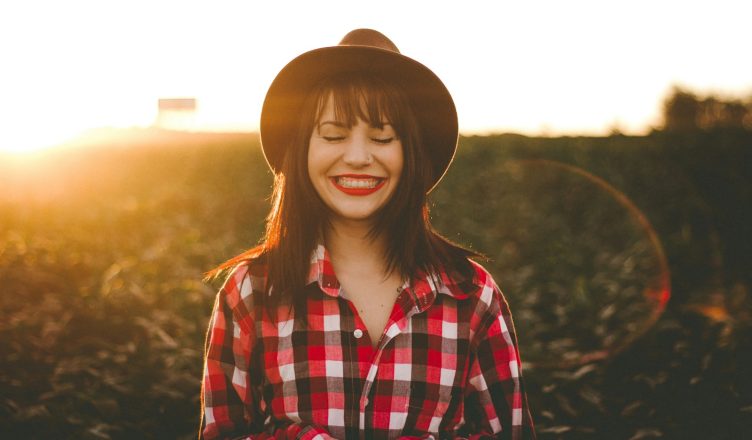 golden hour photography of woman in red and white checkered dress shirt