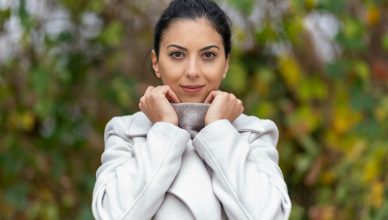 a woman in a bathrobe holding a cup of coffee